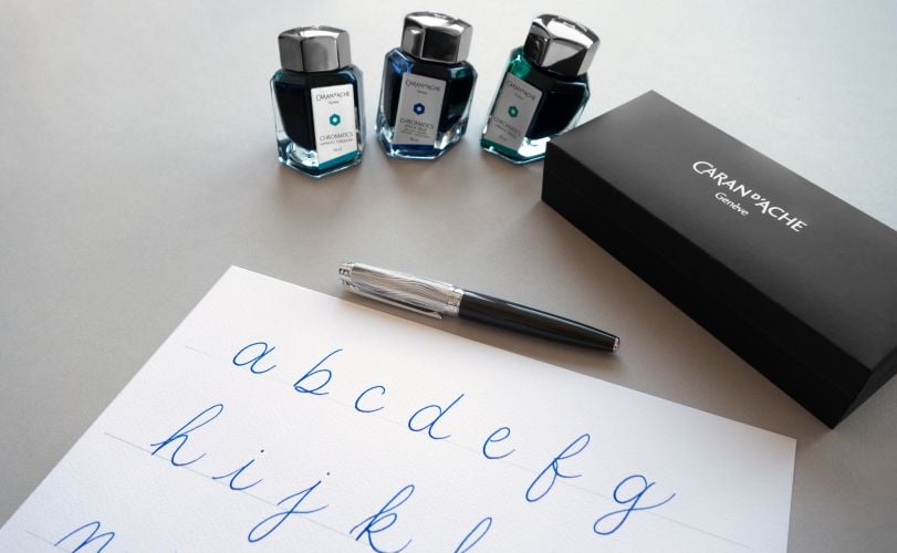 writing of the alphabet with the chromatics divine inkwell and a fountain pen